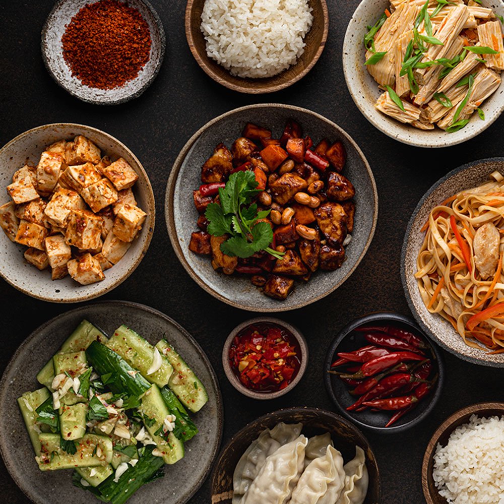 chinese food, chinese traditional cuisine dishes on dark background, top view, copy space