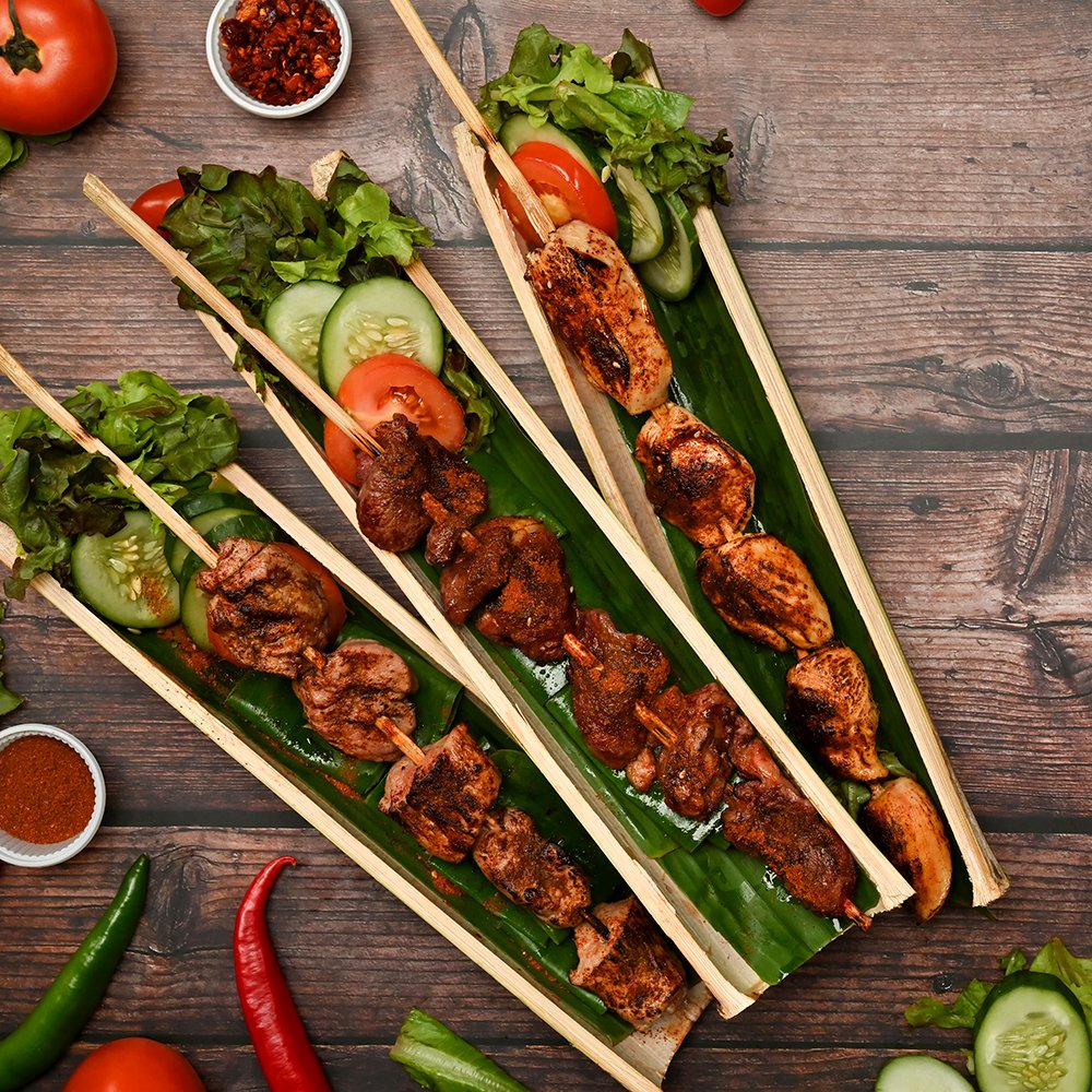 Hot and spicy and delicious street food, grilled meat with Sichuan pepper and vegetable on wooden background.